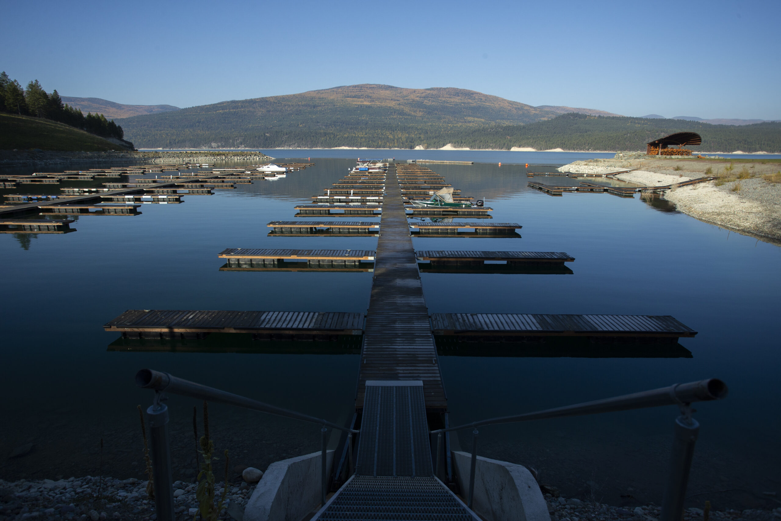 A boat launch and marina in calm water