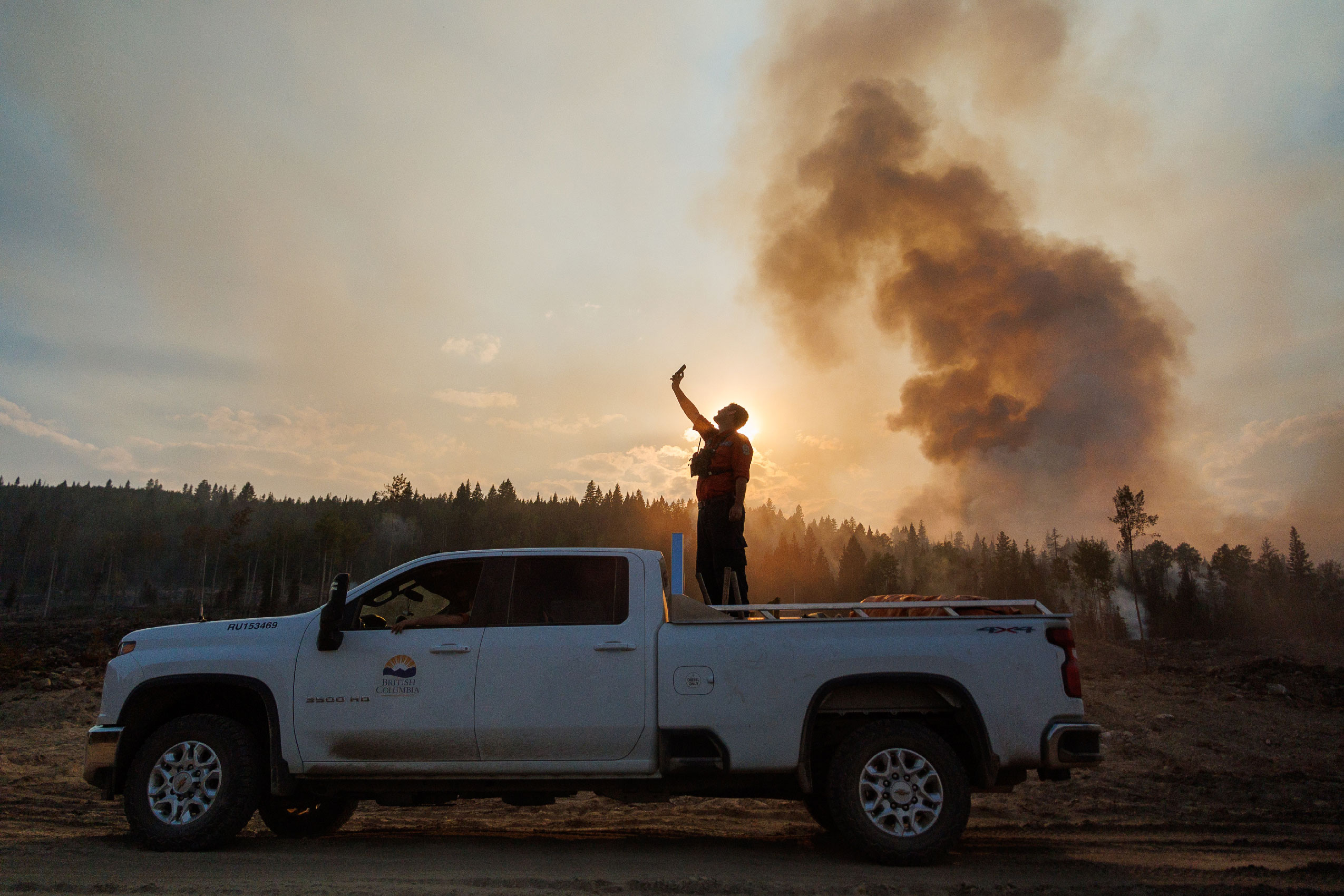 A B.C. Wildfire Service crew leader tries to get cell phone reception in a dead zone on the Rossmoore Lake Wildfire outside Kamloops, B.C.